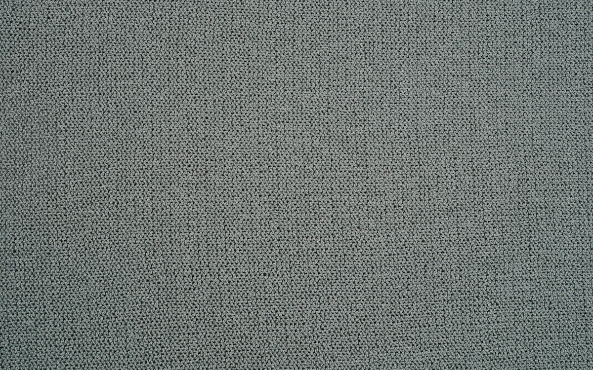Grau-beiger, grob strukturierter Canvas-Stoff.